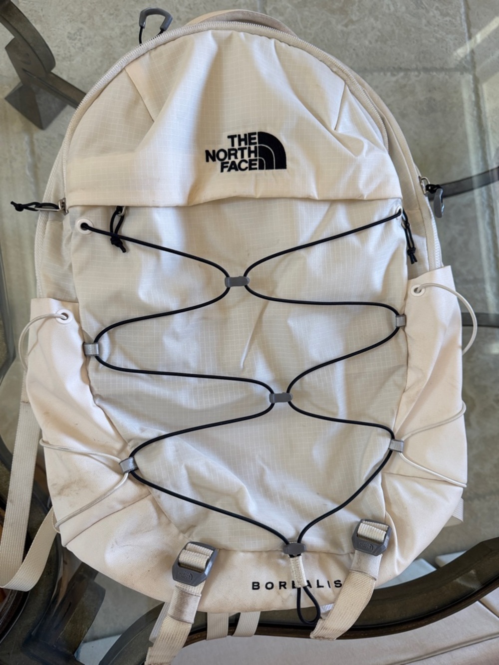 The North Face Cream Backpack with Black Bungee Cord